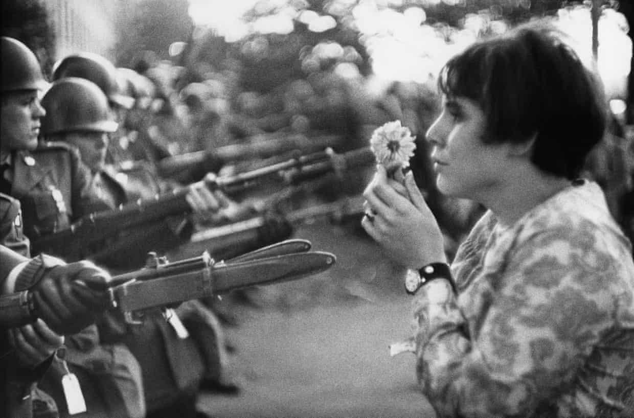 Washington, US · 1967 — A flower faces armed guards
